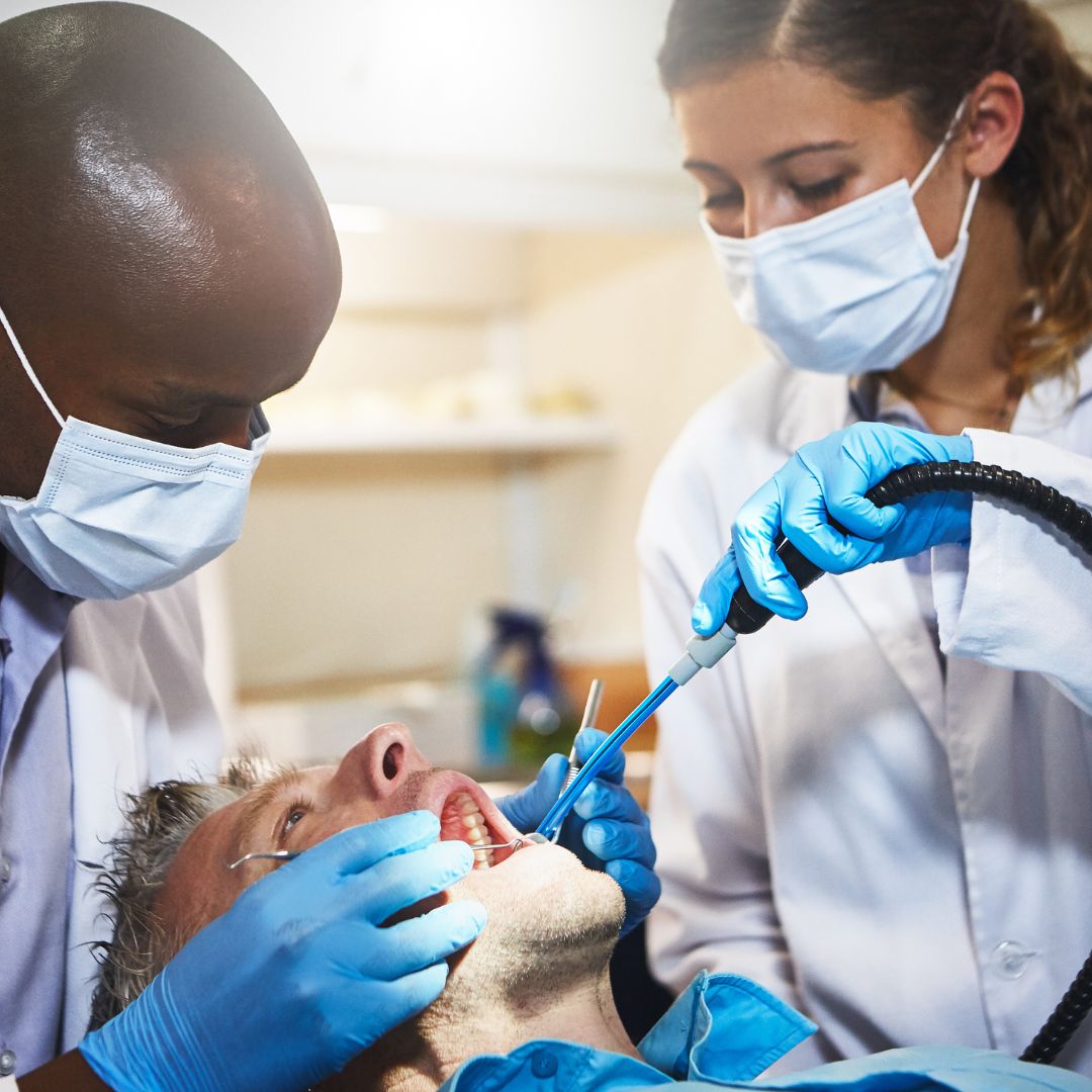 Dentist and dental assistant with patient