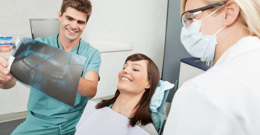 assistant showing patient an X-ray