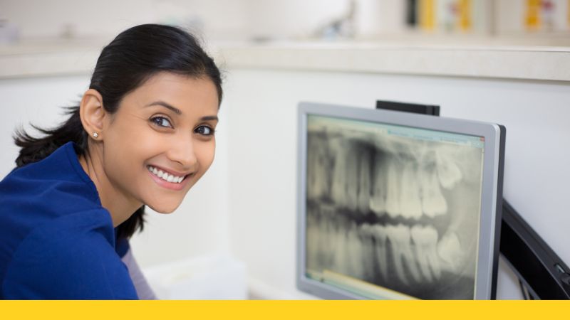 dental assistant viewing x rays