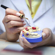 dentist pointing at model teeth